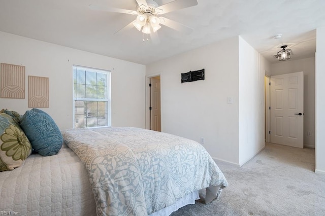 bedroom with ceiling fan, baseboards, and light carpet