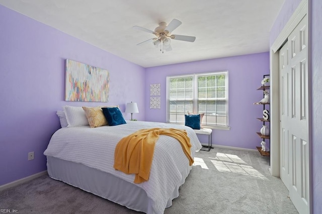 carpeted bedroom featuring baseboards, a ceiling fan, and a closet