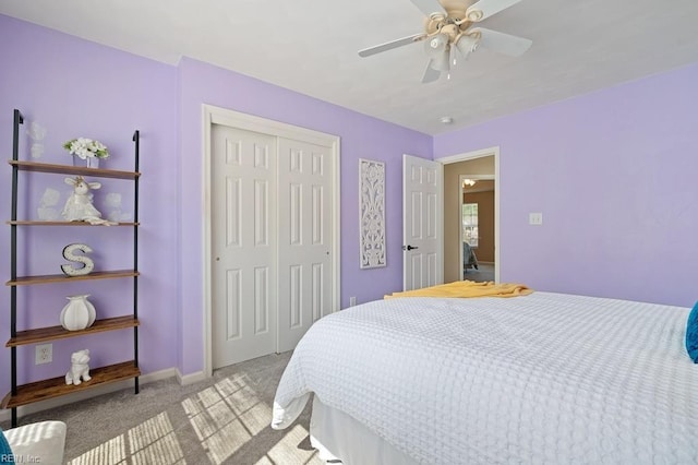 carpeted bedroom with baseboards, a ceiling fan, and a closet