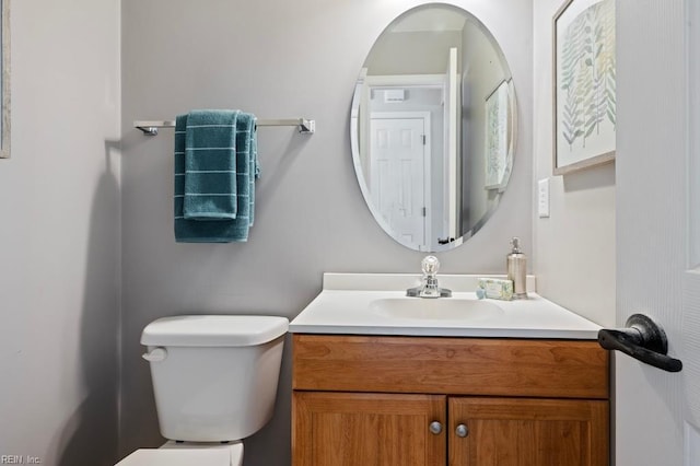 half bathroom featuring toilet and vanity