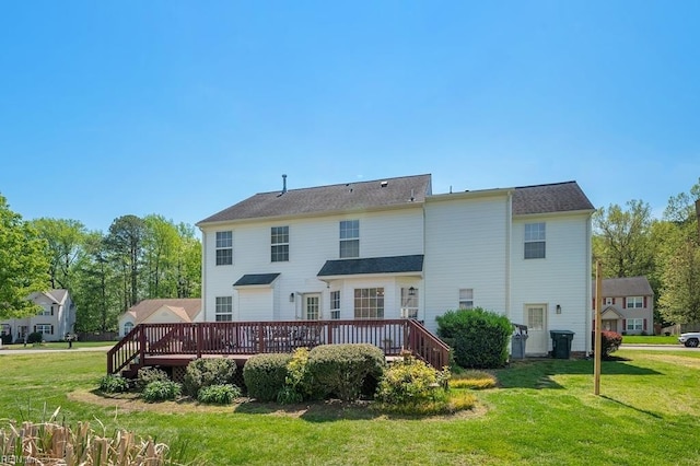 back of house with a lawn and a deck