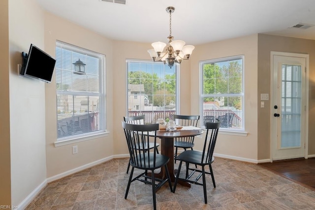 dining room featuring baseboards, a notable chandelier, and visible vents