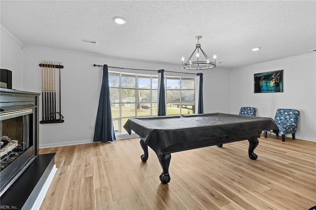 recreation room with pool table, a textured ceiling, visible vents, and light wood-style floors