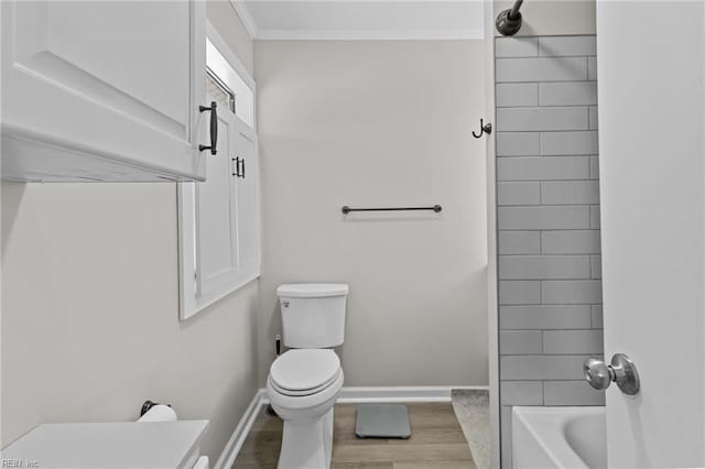 full bath with toilet, ornamental molding, wood finished floors, and baseboards