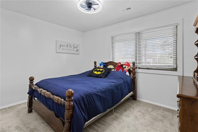 bedroom featuring baseboards, a textured ceiling, visible vents, and carpet