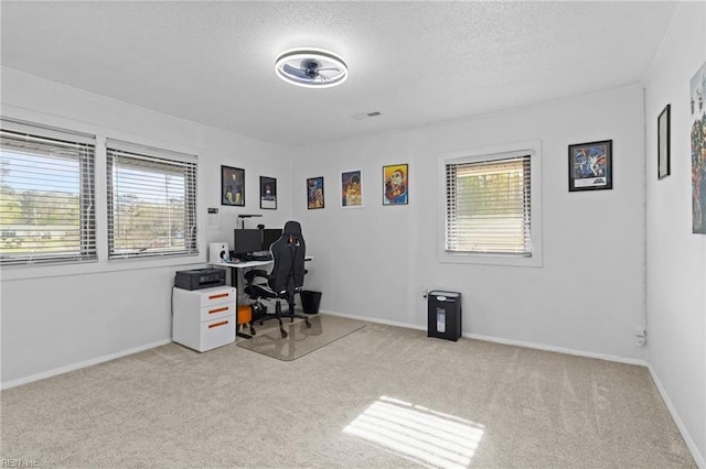 office space featuring baseboards, a textured ceiling, visible vents, and carpet