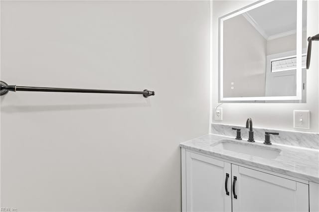 bathroom featuring crown molding and vanity