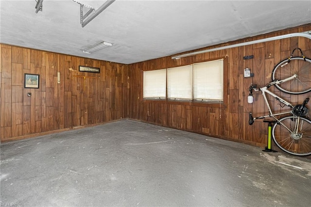 interior space with concrete flooring and wooden walls