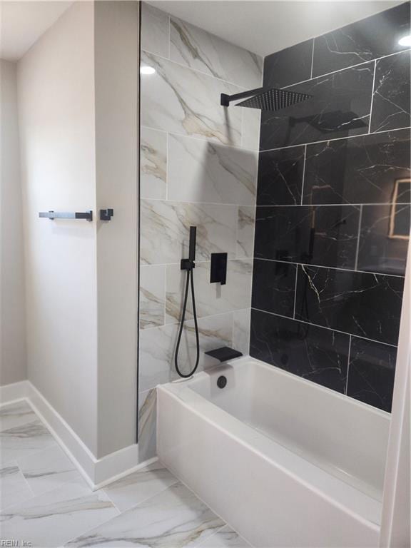 full bath featuring marble finish floor, baseboards, and shower / tub combination