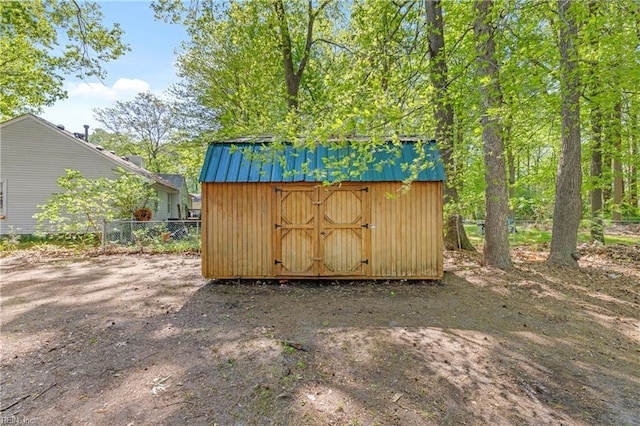 view of shed with fence