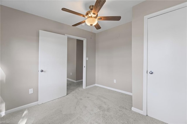 unfurnished bedroom with a ceiling fan, baseboards, and carpet floors