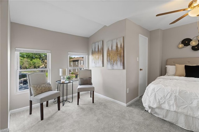 carpeted bedroom with lofted ceiling, a ceiling fan, and baseboards