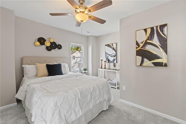 carpeted bedroom with a ceiling fan and baseboards