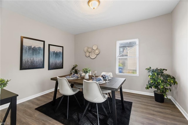 dining area with wood finished floors and baseboards