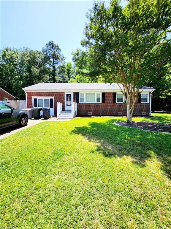 ranch-style house featuring brick siding, crawl space, and a front yard