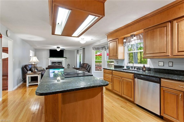 kitchen featuring a center island, a sink, light wood-type flooring, brown cabinetry, and dishwasher