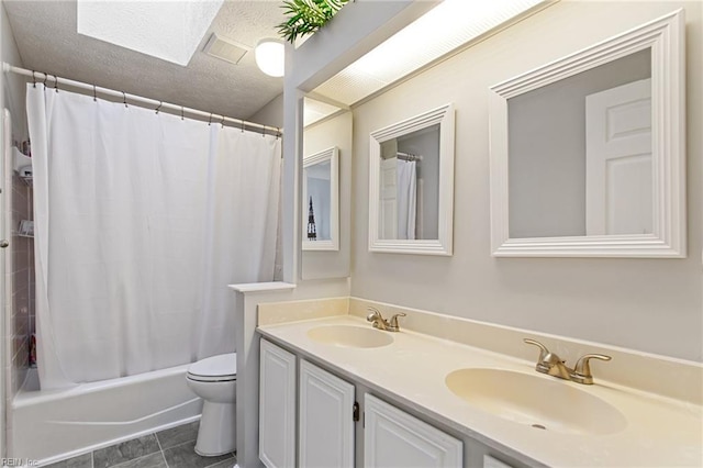 full bath with double vanity, shower / bath combo with shower curtain, toilet, and a sink