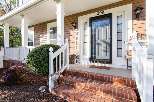 view of exterior entry with a porch
