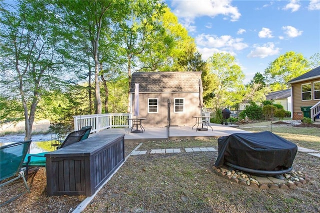 exterior space featuring a wooden deck and an outdoor structure