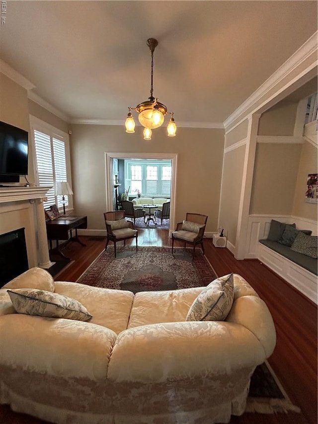 living room with ornamental molding, wood finished floors, and plenty of natural light