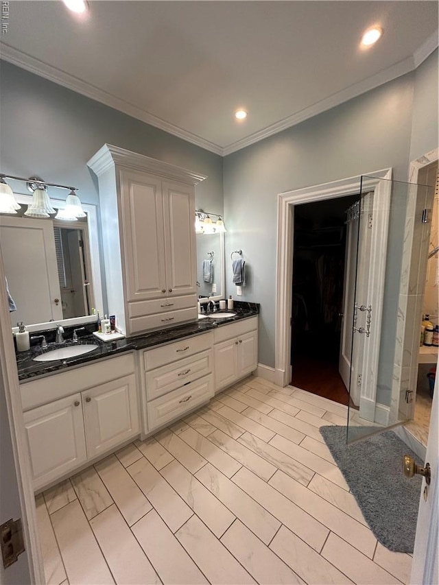 full bathroom featuring a sink, crown molding, recessed lighting, and double vanity