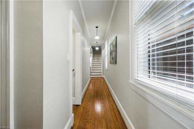 hall featuring baseboards and wood finished floors