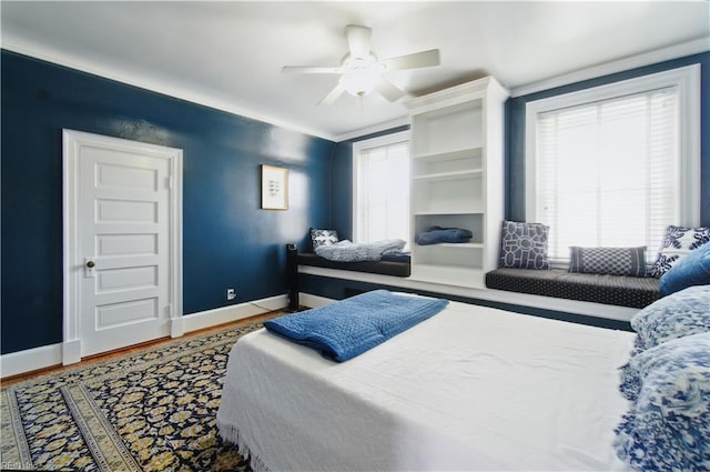 bedroom with baseboards, ceiling fan, and wood finished floors