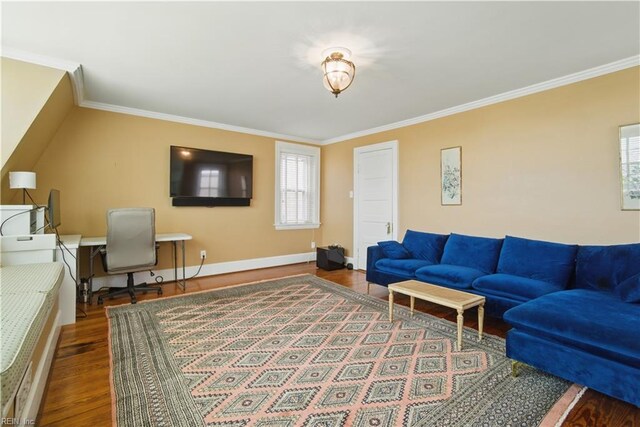 living area with crown molding, baseboards, and wood finished floors