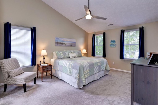 bedroom featuring vaulted ceiling, ceiling fan, light carpet, baseboards, and visible vents