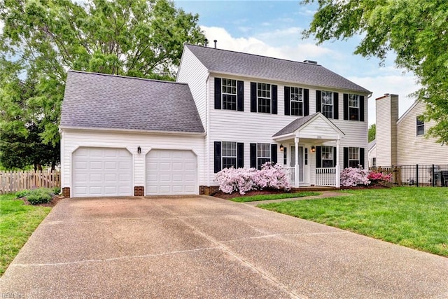 colonial-style house featuring fence, a front lawn, driveway, covered porch, and a garage