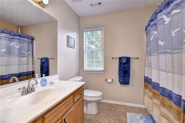 bathroom with visible vents, toilet, vanity, baseboards, and a textured ceiling
