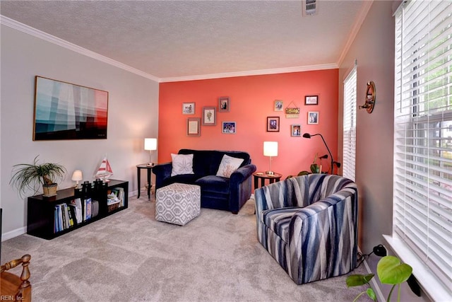 carpeted living room with visible vents, a textured ceiling, and ornamental molding