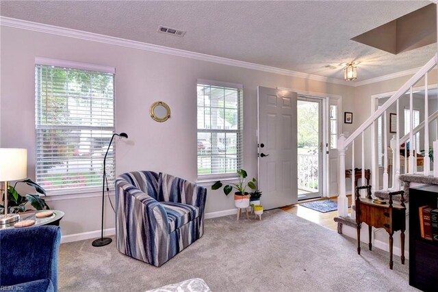 interior space featuring a textured ceiling, a healthy amount of sunlight, and stairs