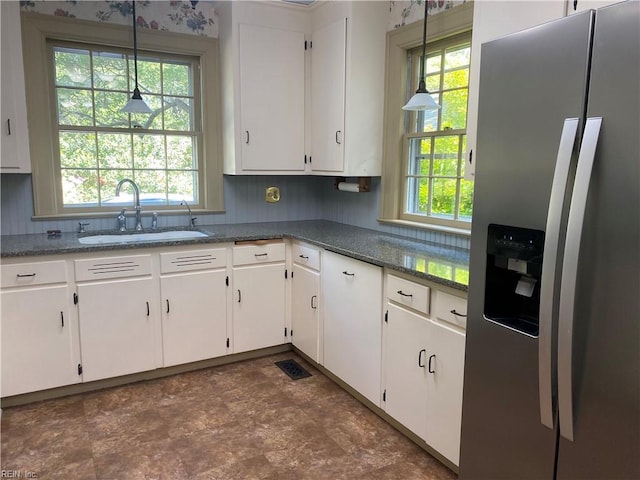 26060 Court St, Courtland, VA 23837 - kitchen with white cabinets, stainless steel refrigerator with ice dispenser, decorative light fixtures, and a sink