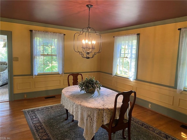 26060 Court St, Courtland, VA 23837 - dining area with wood finished floors, visible vents, ornamental molding, wainscoting, and a chandelier
