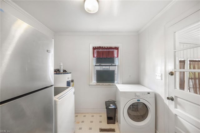 washroom with laundry area, crown molding, baseboards, separate washer and dryer, and electric water heater
