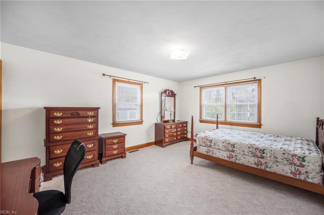 bedroom featuring light carpet, visible vents, and baseboards