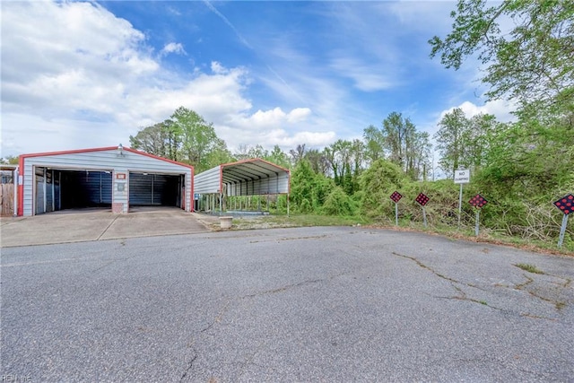 detached garage featuring a detached carport
