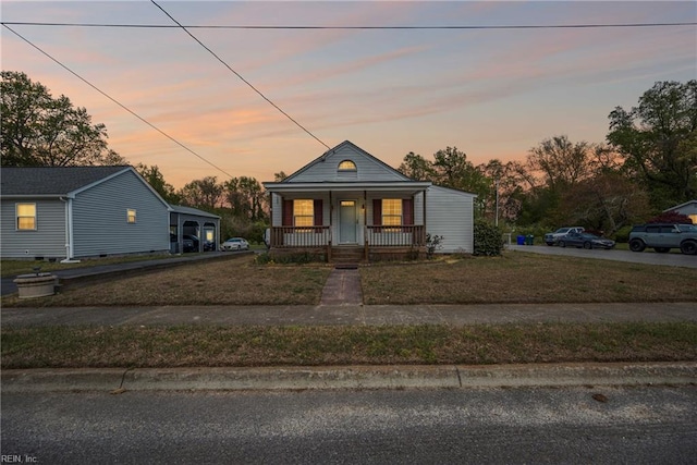 bungalow-style house featuring a yard and covered porch