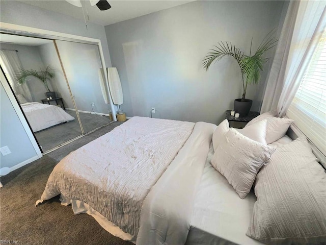 bedroom with baseboards, carpet flooring, and a closet