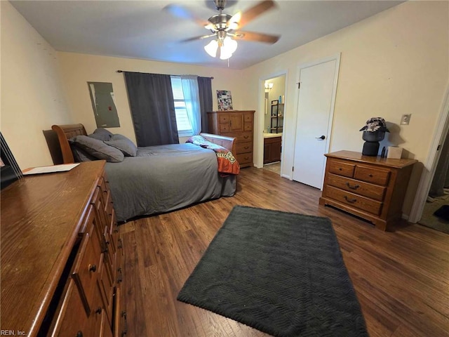 bedroom with ensuite bathroom, wood finished floors, and ceiling fan