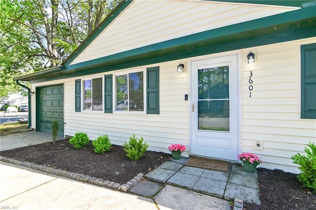 doorway to property featuring driveway and a garage