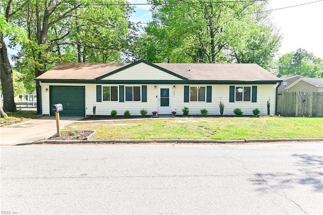 single story home with an attached garage, fence, a front yard, and concrete driveway