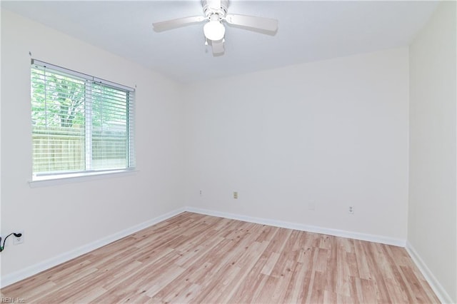 unfurnished room featuring baseboards, a ceiling fan, and light wood finished floors