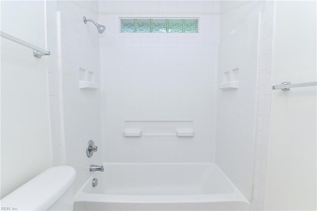bathroom with shower / bathing tub combination and toilet