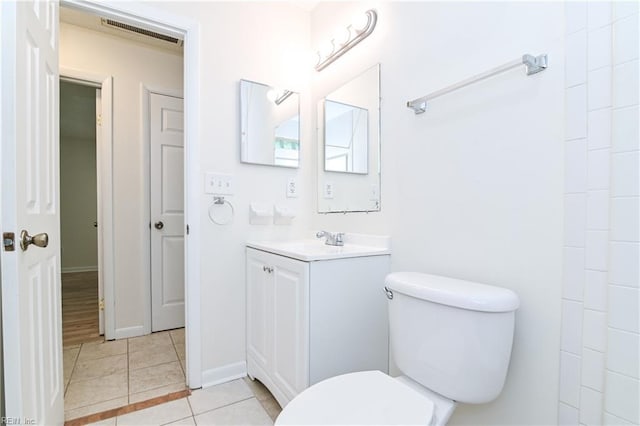 bathroom featuring tile patterned floors, vanity, baseboards, toilet, and visible vents