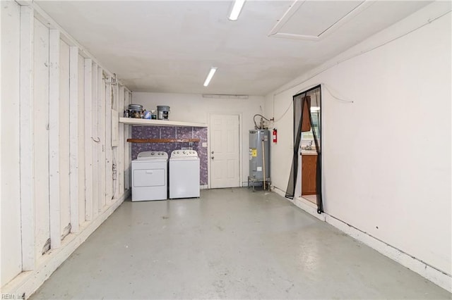 basement with water heater and washer and dryer