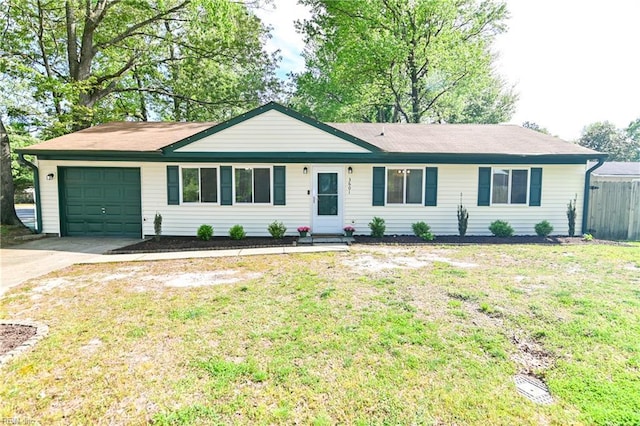 ranch-style house featuring a garage, driveway, a front lawn, and fence