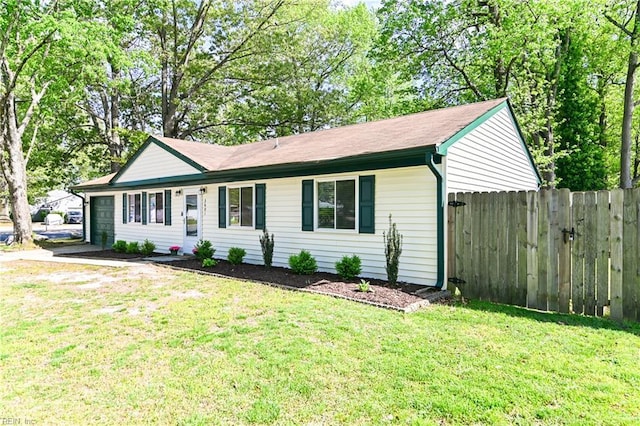 ranch-style home with a front lawn, fence, and a garage