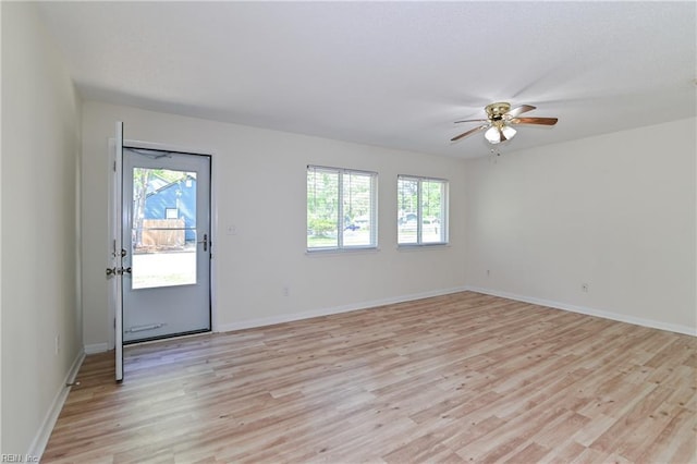 interior space featuring baseboards, light wood-style floors, and ceiling fan